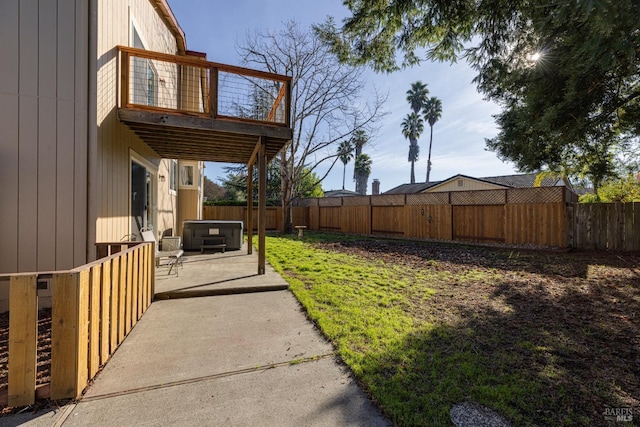 view of yard with a patio area and a hot tub