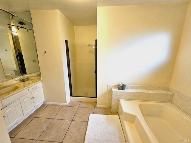 bathroom with plus walk in shower, vanity, and tile patterned floors