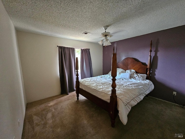 carpeted bedroom featuring ceiling fan and a textured ceiling