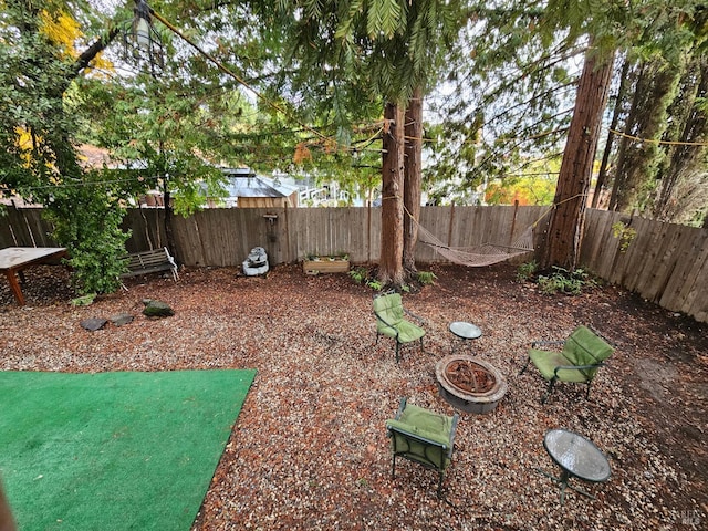 view of yard with an outdoor fire pit