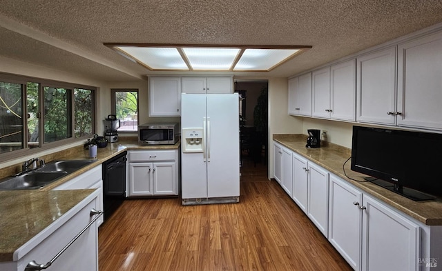 kitchen with dishwasher, white cabinets, light hardwood / wood-style floors, and white refrigerator with ice dispenser