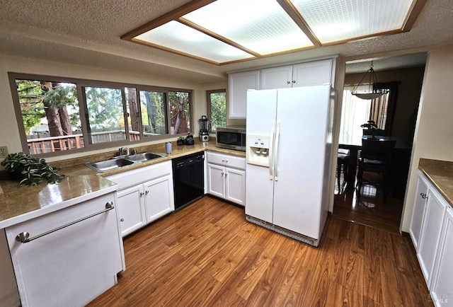 kitchen featuring a textured ceiling, white appliances, sink, white cabinets, and hardwood / wood-style floors