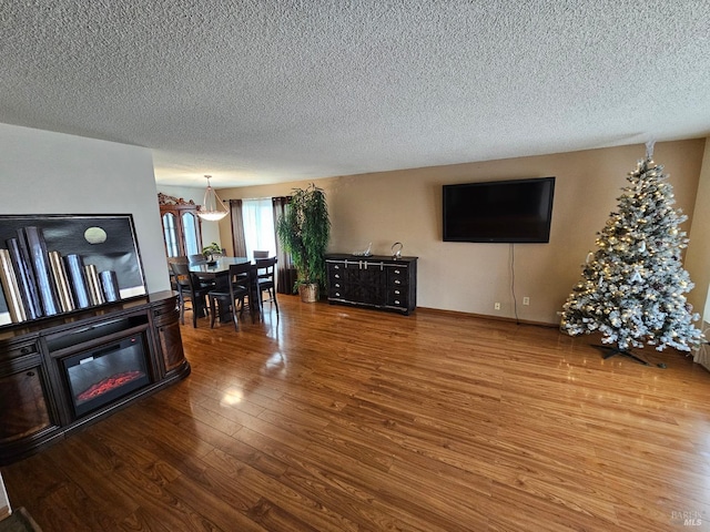 living room featuring hardwood / wood-style floors and a textured ceiling