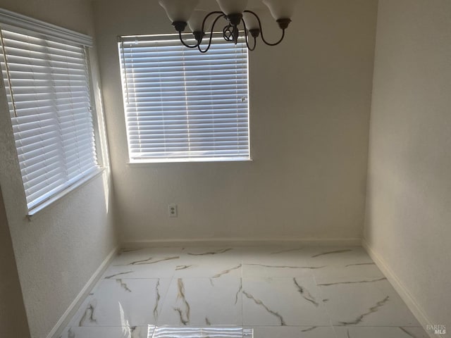 unfurnished dining area featuring an inviting chandelier