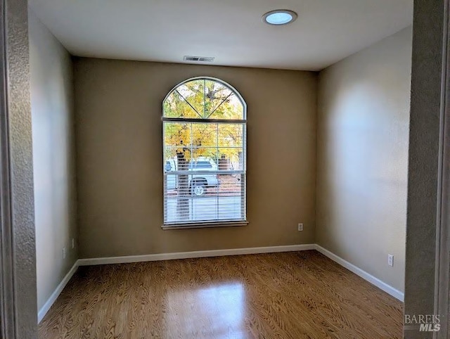 empty room with hardwood / wood-style flooring