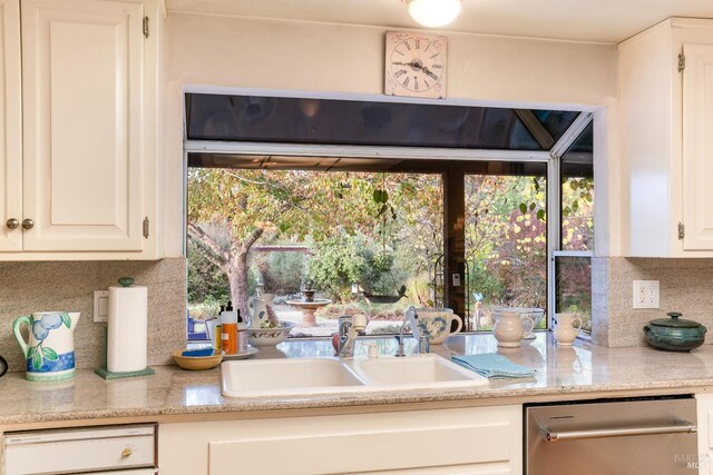 kitchen featuring white cabinetry, sink, and decorative backsplash