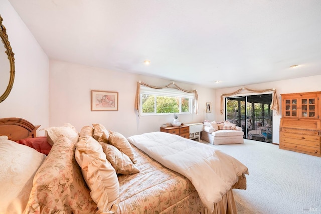 bedroom with access to exterior and carpet