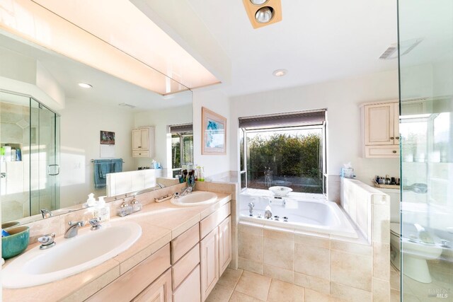 bathroom featuring tile patterned floors, plus walk in shower, and vanity