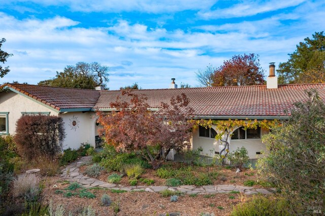 5625 Occidental Rd, Santa Rosa, CA 95401 - rear view of house featuring a tiled roof, a chimney, and stucco siding
