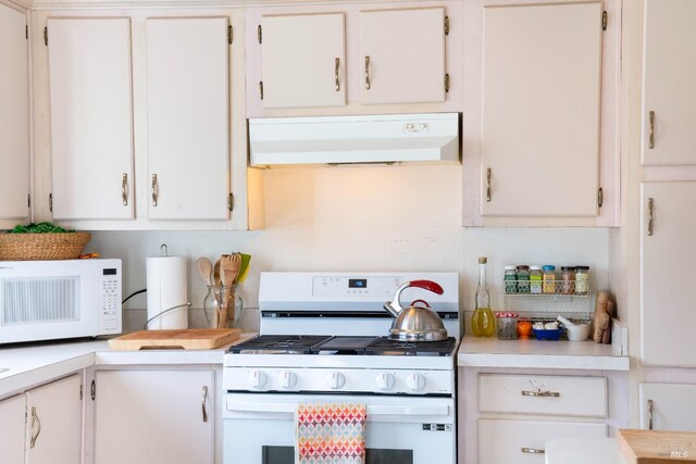 kitchen with white cabinetry and white appliances