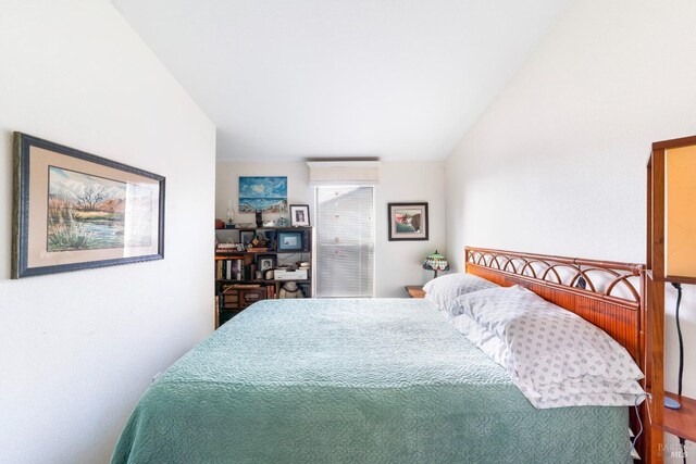 bedroom featuring vaulted ceiling