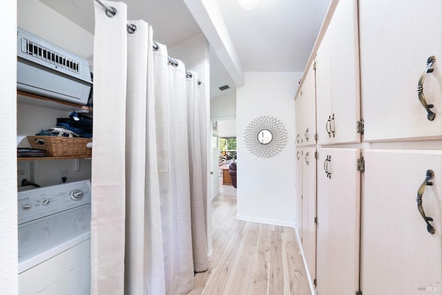 laundry room featuring washer / clothes dryer and light hardwood / wood-style flooring