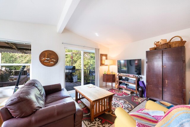 living room with vaulted ceiling with beams and hardwood / wood-style floors