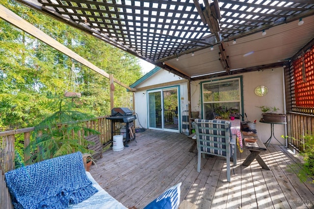 wooden terrace featuring area for grilling and a pergola