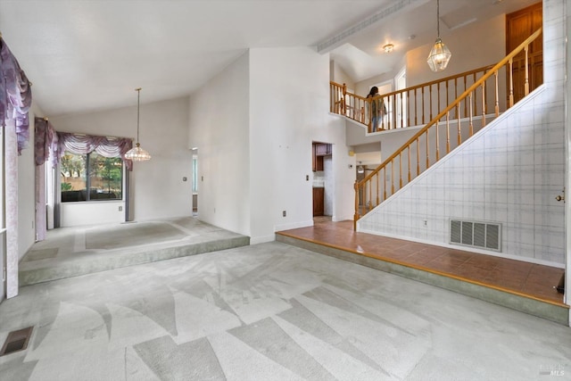 interior space with beamed ceiling and high vaulted ceiling