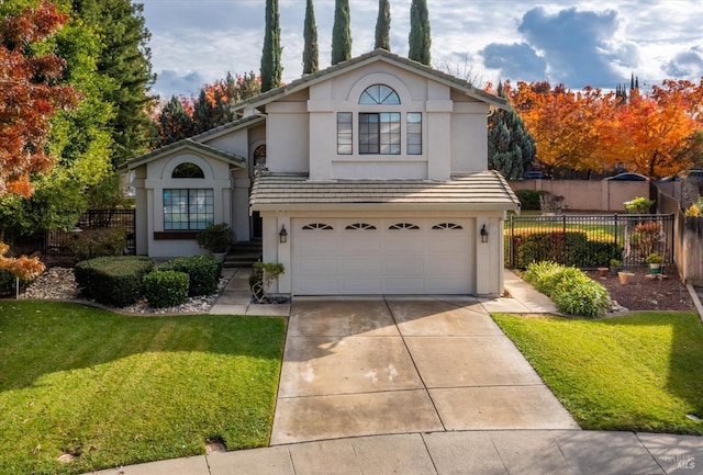 view of front property featuring a garage and a front lawn