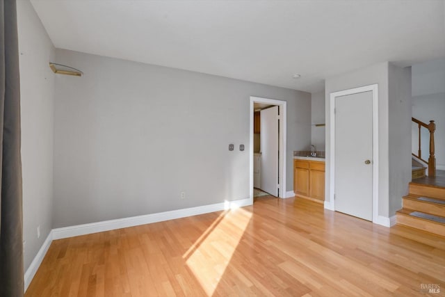 unfurnished room featuring sink and light wood-type flooring