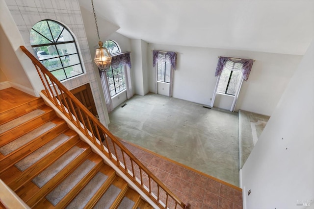 entryway with carpet floors and a wealth of natural light