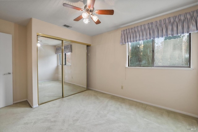 unfurnished bedroom featuring ceiling fan, carpet floors, and a closet