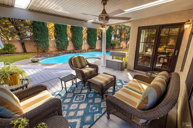 view of pool featuring ceiling fan and a wooden deck