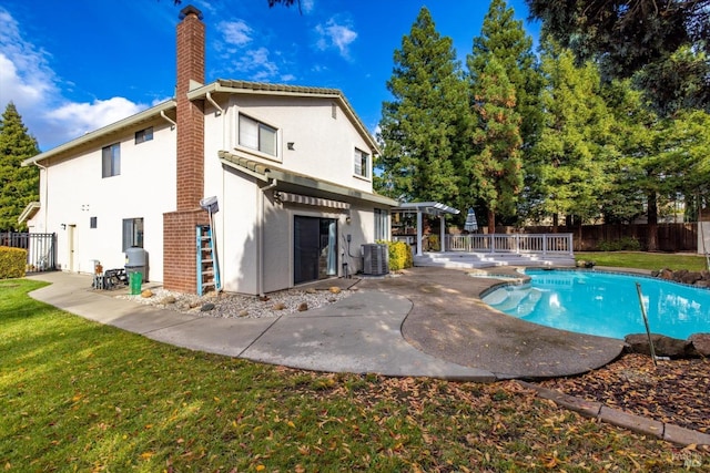 back of property with a fenced in pool, central AC, and a patio