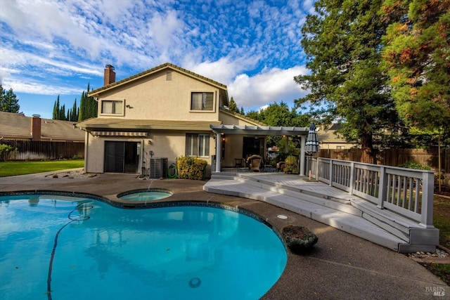 view of swimming pool featuring cooling unit, a pergola, an in ground hot tub, a wooden deck, and a patio