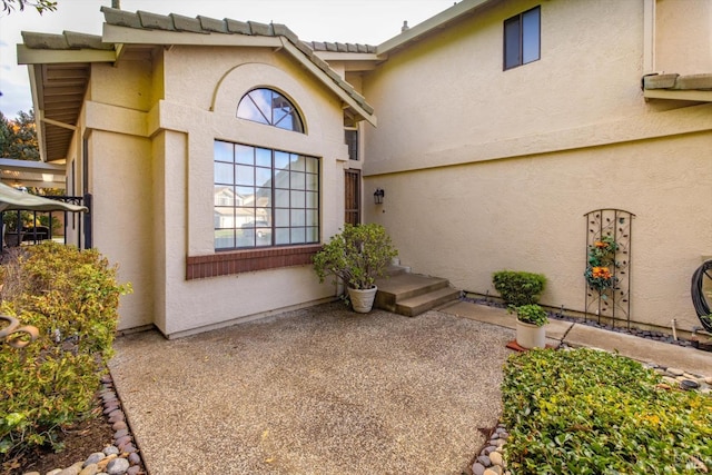 doorway to property with a patio