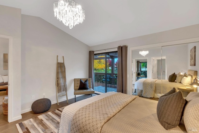 bedroom with a notable chandelier, wood finished floors, lofted ceiling, and access to outside