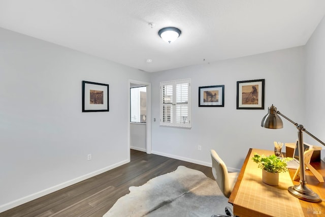 office with dark wood-type flooring and baseboards