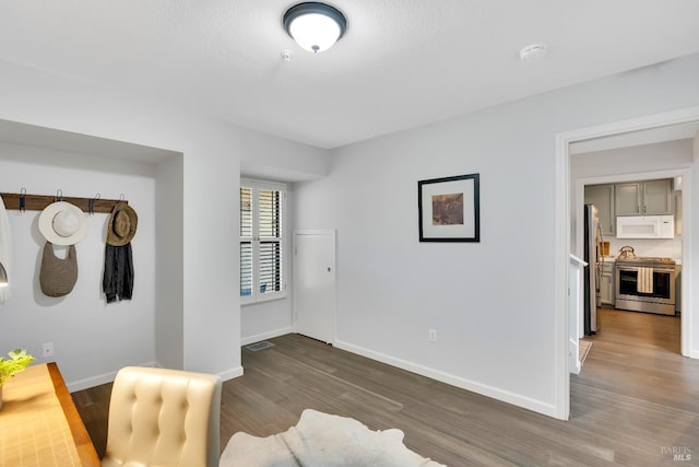 interior space with visible vents, baseboards, and wood finished floors