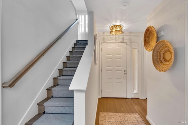 staircase with wood finished floors
