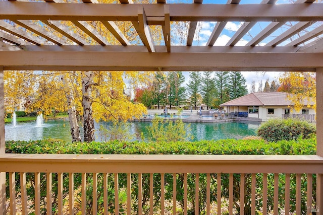 exterior space with a water view and a pergola