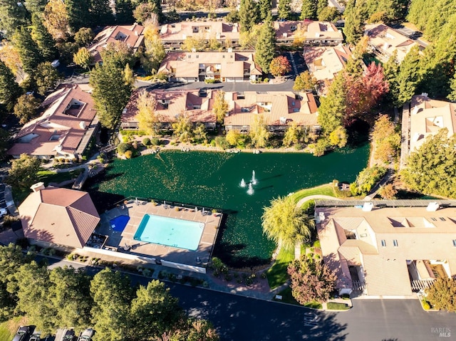 drone / aerial view featuring a residential view and a water view