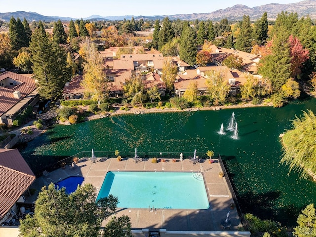drone / aerial view featuring a water and mountain view