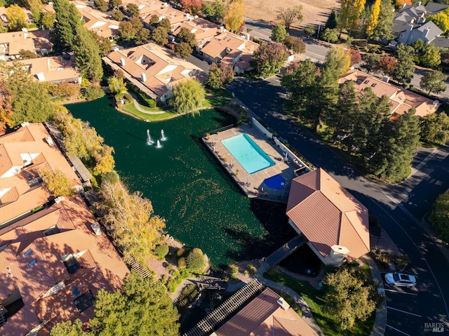 birds eye view of property with a residential view and a water view