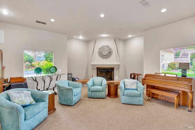 carpeted living room with plenty of natural light, recessed lighting, and visible vents