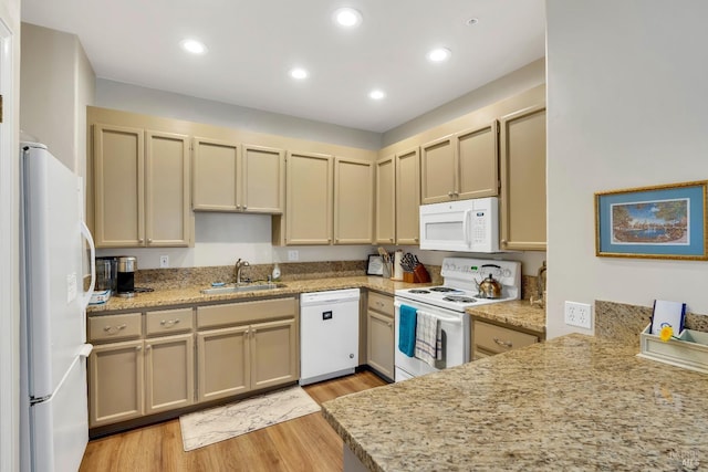 kitchen featuring a sink, white appliances, light wood-style flooring, and recessed lighting