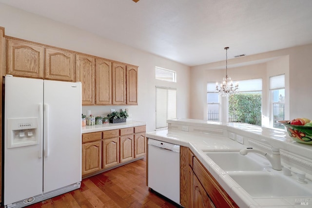 kitchen with white appliances, sink, dark hardwood / wood-style floors, tile counters, and a chandelier