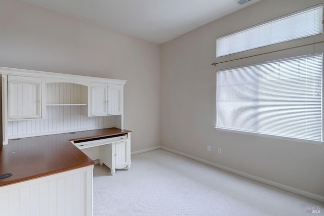 unfurnished office featuring light carpet and plenty of natural light