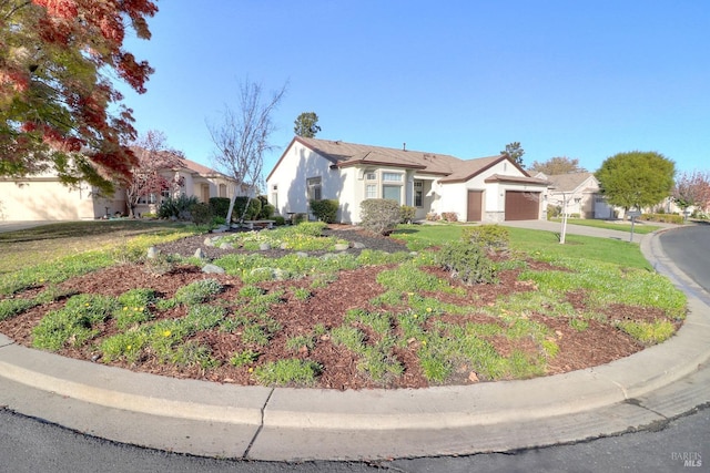 view of front of home with a garage and a front lawn