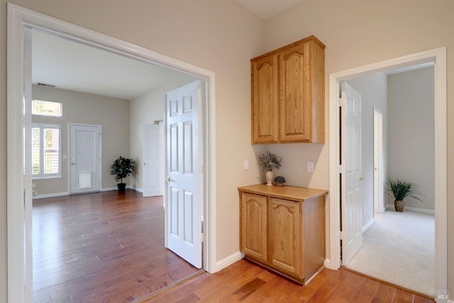 hall with hardwood / wood-style flooring