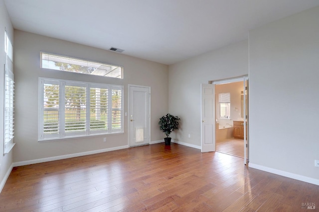 spare room with wood-type flooring