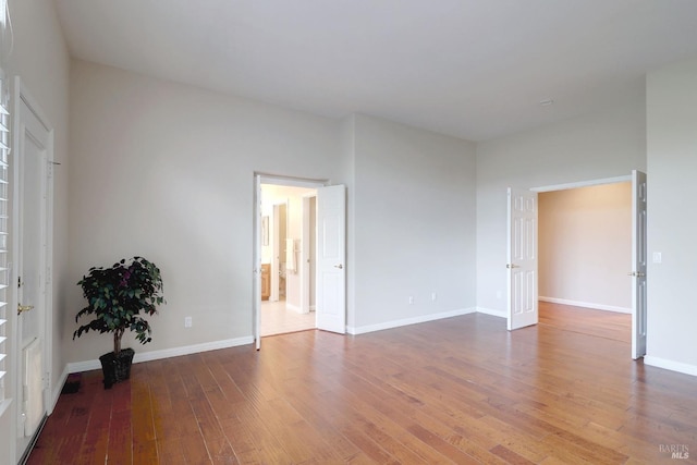 unfurnished room with hardwood / wood-style floors