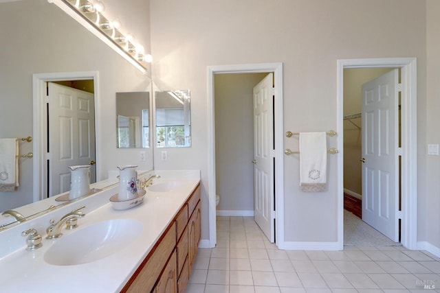 bathroom featuring toilet, vanity, and tile patterned floors