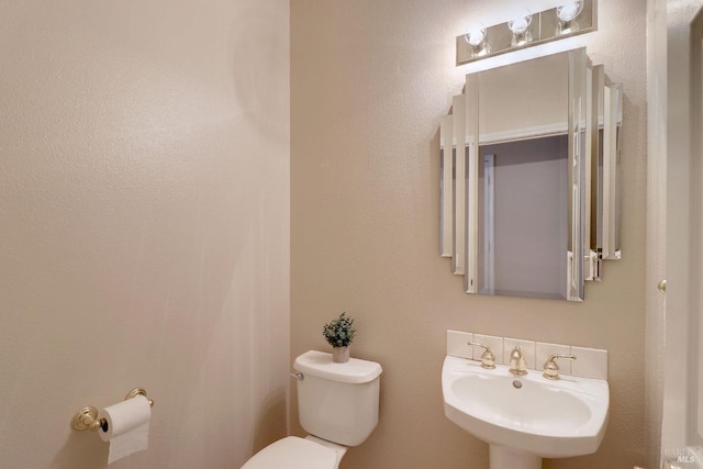 bathroom with toilet and sink