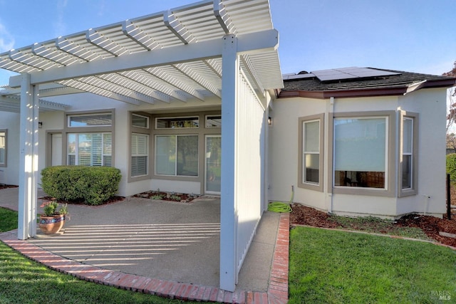 property entrance with a pergola and a yard