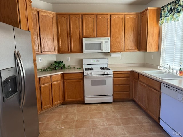 kitchen featuring white appliances and sink