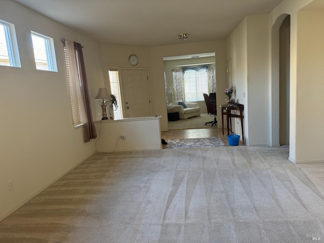 entryway with light carpet and plenty of natural light