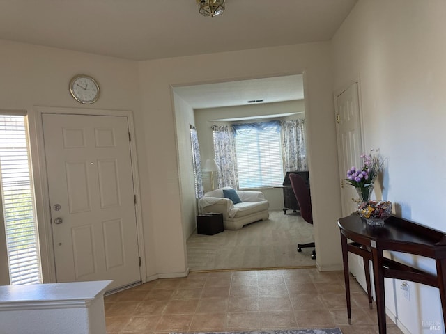 view of carpeted foyer