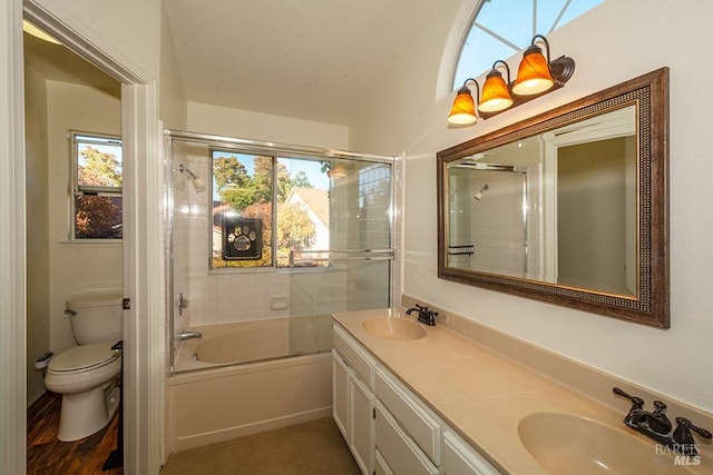 full bathroom with shower / bath combination with glass door, vanity, and toilet